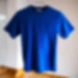 A stylish blue t-shirt displayed on a minimalist background